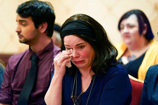 Veronique De La Rosa, mother of Noah Pozner, who was killed in the Sandy Hook Elementary School shooting, wipes away tears during a news conference in Trumbull, Conn., Tuesday, Feb. 15, 2022. The families of nine victims of the Sandy Hook Elementary School shooting have agreed to a $73 million settlement of a lawsuit against the maker of the rifle used to kill 20 first graders and six educators in 2012, their attorney said Tuesday. (AP Photo/Seth Wenig)    PHOTO CREDIT: Seth Wenig