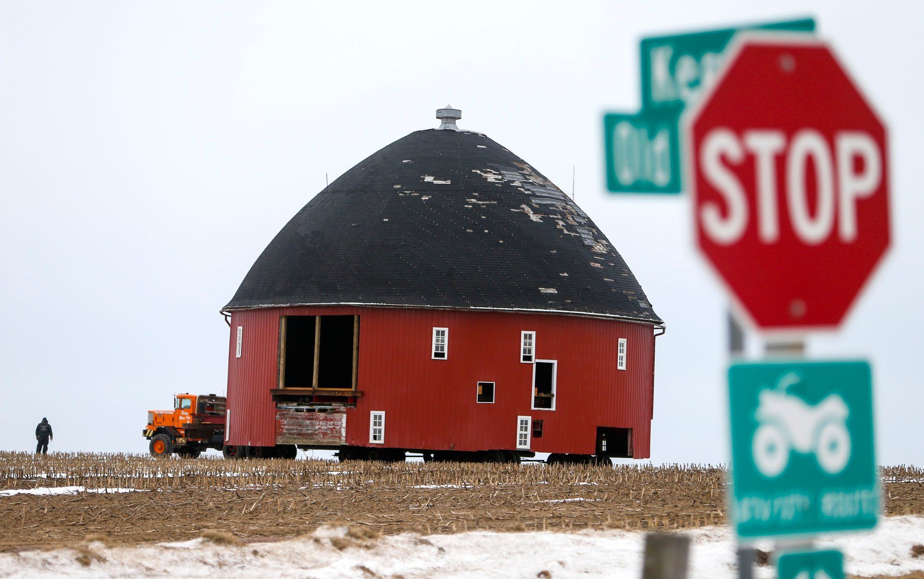 Crews work on moving a 60-foot round barn through a farm field near Old Potosi Road in Lancaster, Wis., on Thursday. Vesperman Farms moved the barn to its property a few miles away.    PHOTO CREDIT: Dave Kettering