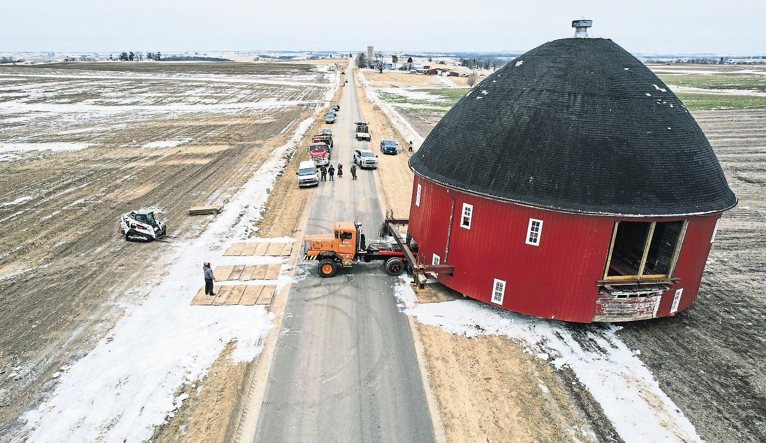 Crews work on moving a 60-foot round barn across Old Potosi Road in Lancaster, Wis., on Thursday. Vesperman Farms moved the barn to its property a few miles away.    PHOTO CREDIT: Dave Kettering