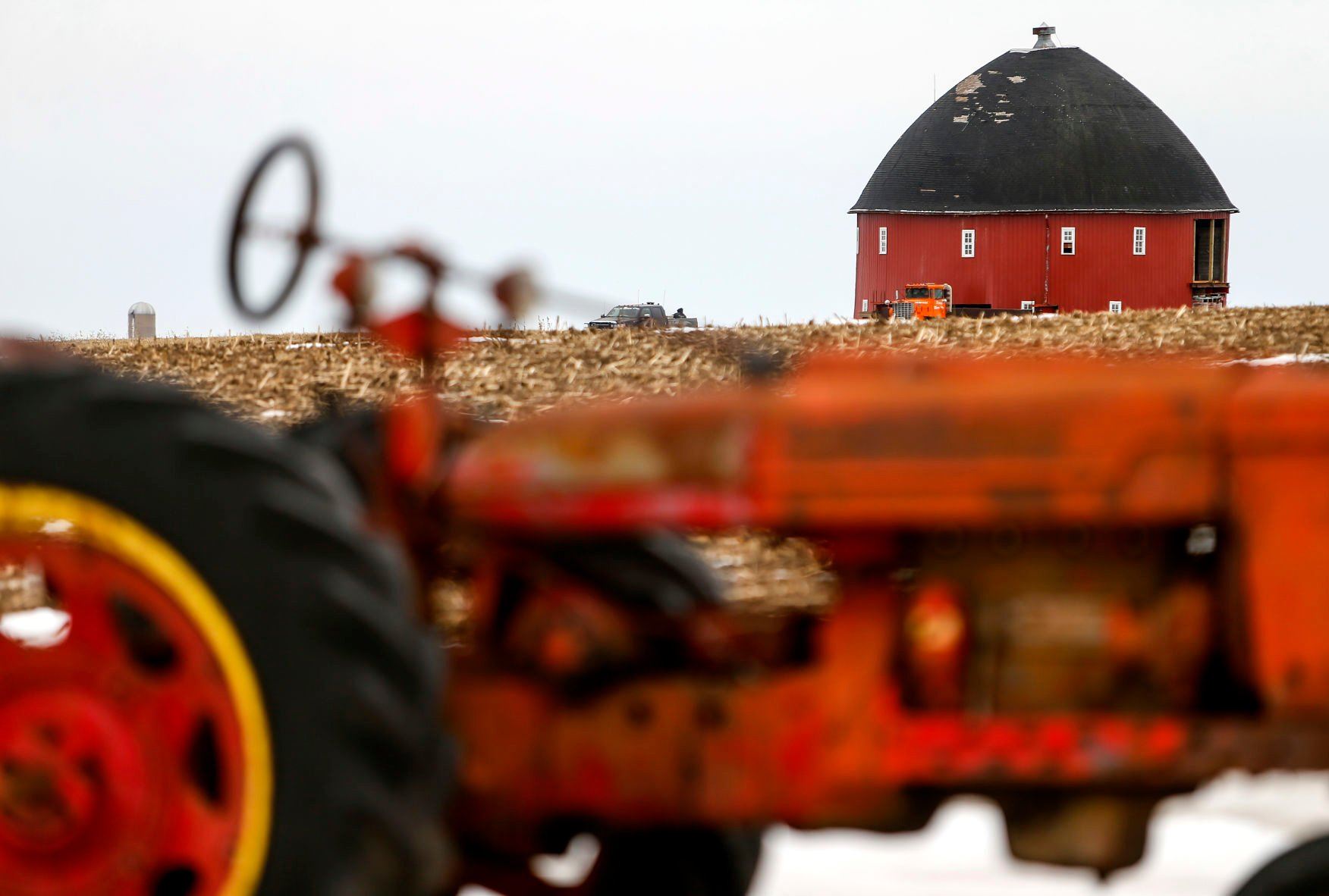 A 60-foot round barn slowly moves across a farm field close to it