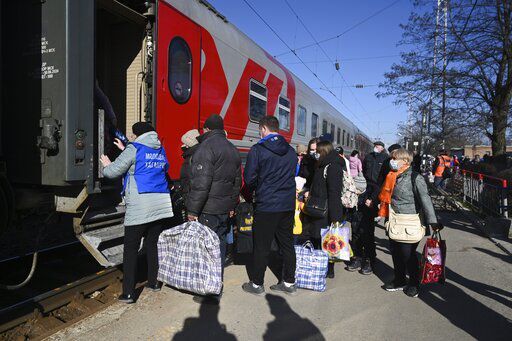 People from the Donetsk and Luhansk regions, the territory controlled by pro-Russia separatist governments in eastern Ukraine, get on a train to be taken to temporary residences in other regions of Russia, at the railway station in Taganrog, Russia, Monday, Feb. 21, 2022. World leaders are making another diplomatic push in hopes of preventing a Russian invasion of Ukraine, even as heavy shelling continues in Ukraine