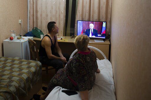 People from the Donetsk and Luhansk regions, the territory controlled by a pro-Russia separatist governments in eastern Ukraine, watch Russian President Vladimir Putin