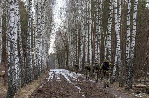 Ukrainian border guard officers patrol the Ukrainian-Belarusian state border at a checkpoint in Novi Yarylovychi, Ukraine, Monday, Feb.21, 2022.(AP Photo/Oleksandr Ratushniak)    PHOTO CREDIT: Oleksandr Ratushniak