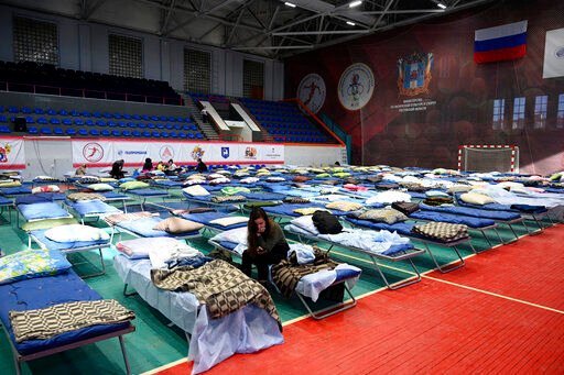 Displaced civilians from the Donetsk and Luhansk regions, the territory controlled by pro-Russia separatist governments in eastern Ukraine, rest in a sport hall in Taganrog, Russia, Monday, Feb. 21, 2022. World leaders are making another diplomatic push in hopes of preventing a Russian invasion of Ukraine, even as heavy shelling continues in Ukraine