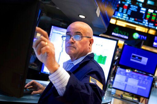 In this photo provided by the New York Stock Exchange, trader Anthony Confusione works on the floor, Tuesday, Feb 22, 2022. Stocks shifted between small gains and losses in morning trading on Wall Street Tuesday as tensions escalated in Ukraine over Russia