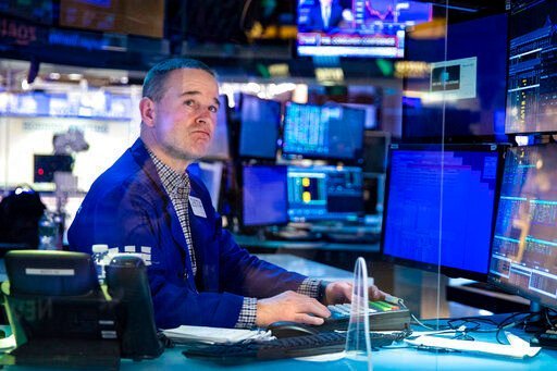 In this photo provided by the New York Stock Exchange, specialist Stephen Naughton works at his post on the trading floor, Tuesday, Feb 22, 2022. Stocks shifted between small gains and losses in morning trading on Wall Street Tuesday as tensions escalated in Ukraine over Russia