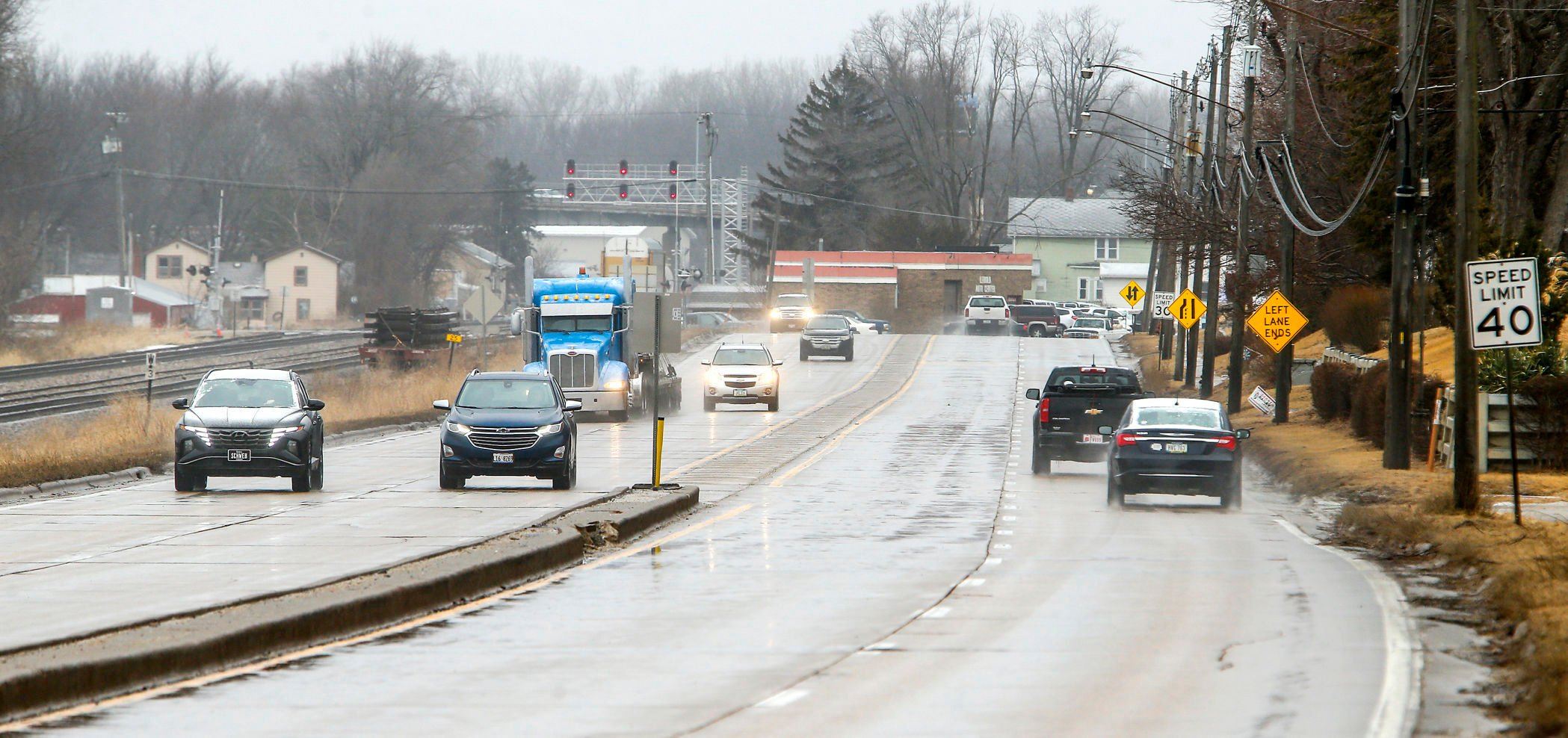 Traffic moves along U.S. 20 in East Dubuque, Ill., on Tuesday. A section of the road will be converted from four lanes to three, with the center portion being a bi-directional turning lane in an effort to reduce front-to-rear collisions.    PHOTO CREDIT: Dave Kettering