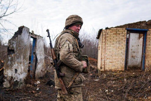 A Ukrainian serviceman stands at his position at the line of separation between Ukraine-held territory and rebel-held territory near Svitlodarsk, eastern Ukraine on Wednesday.    PHOTO CREDIT: Evgeniy Maloletka