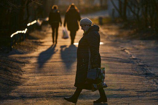 A woman walks in Sievierodonetsk, the Luhansk region, eastern Ukraine, Wednesday, Feb. 23, 2022. Ukraine urged its citizens to leave Russia, and Europe braced for further confrontation Wednesday after tensions escalated dramatically when Russia