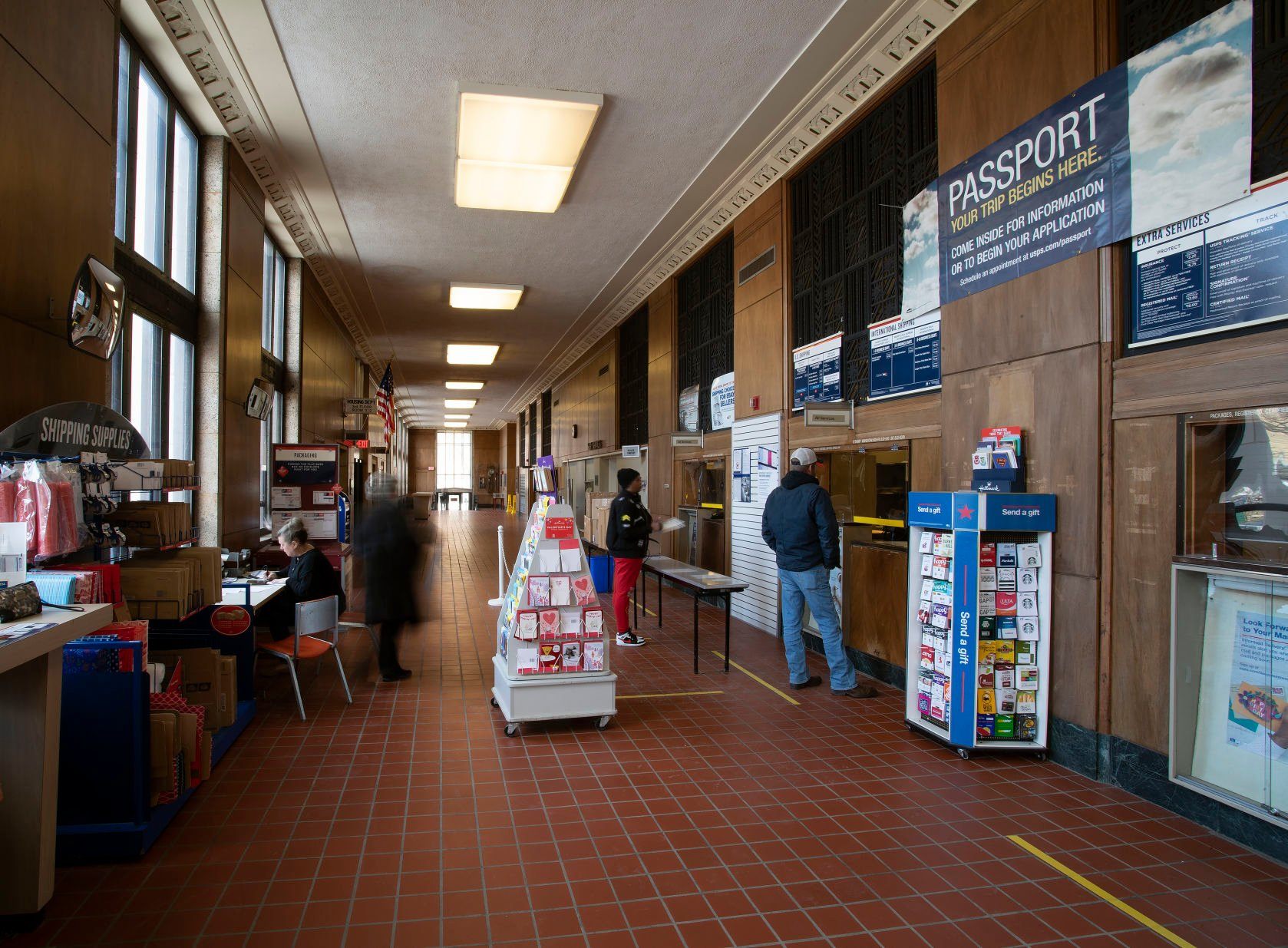 Customers stand in the lobby of the post office located inside the historic Federal Building in Dubuque on Wednesday, Feb. 23, 2022.    PHOTO CREDIT: Stephen Gassman