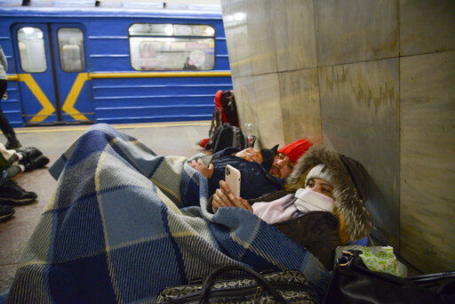 People lie in the Kyiv subway, using it as a bomb shelter in Kyiv, Ukraine, Thursday, Feb. 24, 2022. Russia has launched a full-scale invasion of Ukraine, unleashing airstrikes on cities and military bases and sending troops and tanks from multiple directions in a move that could rewrite the world