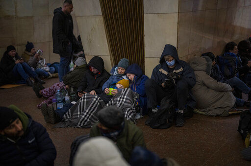 People rest in the Kyiv subway, using it as a bomb shelter in Kyiv, Ukraine, Thursday, Feb. 24, 2022. Russia has launched a full-scale invasion of Ukraine, unleashing airstrikes on cities and military bases and sending troops and tanks from multiple directions in a move that could rewrite the world