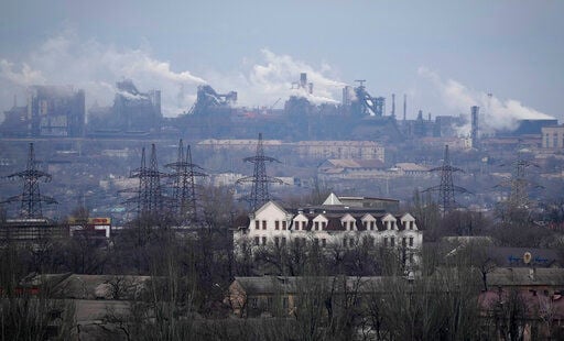 A metallurgical plant is seen on the outskirts of the city of Mariupol, Ukraine, Thursday, Feb. 24, 2022. Russia has launched a barrage of air and missile strikes on Ukraine early Thursday and Ukrainian officials said that Russian troops have rolled into the country from the north, east and south. (AP Photo/Sergei Grits)    PHOTO CREDIT: Sergei Grits