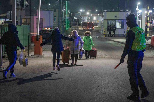 A Ukrainian family reunites at the Medyka border crossing in Poland. The U.N. refugee agency said today that more than 500,000 people have fled Ukraine since Russia invaded the country last week.    PHOTO CREDIT: Visar Kryeziu