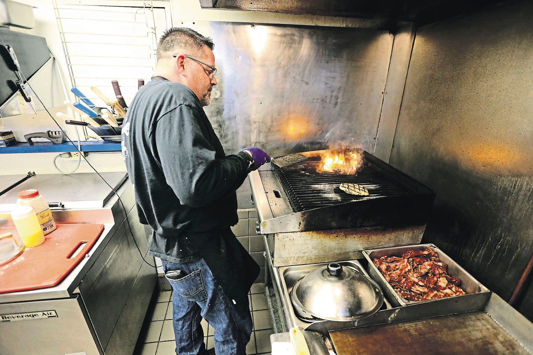 Chuck Bowers makes a chicken bacon ranch burger at Foodie Garage Eatery in Dubuque on Friday, April 23, 2021.    PHOTO CREDIT: JESSICA REILLY
Telegraph Herald