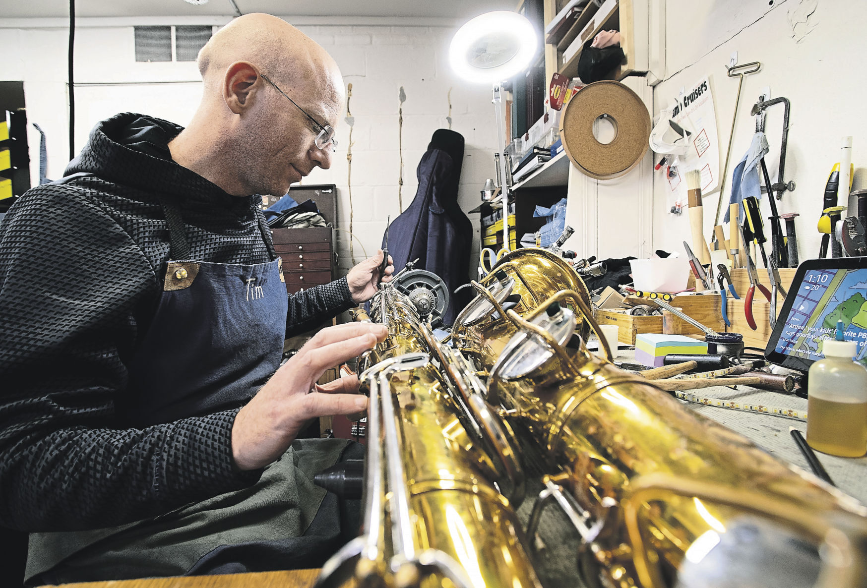 Tim Durst works on a saxophone at Blue Note Music.    PHOTO CREDIT: SYSTEM