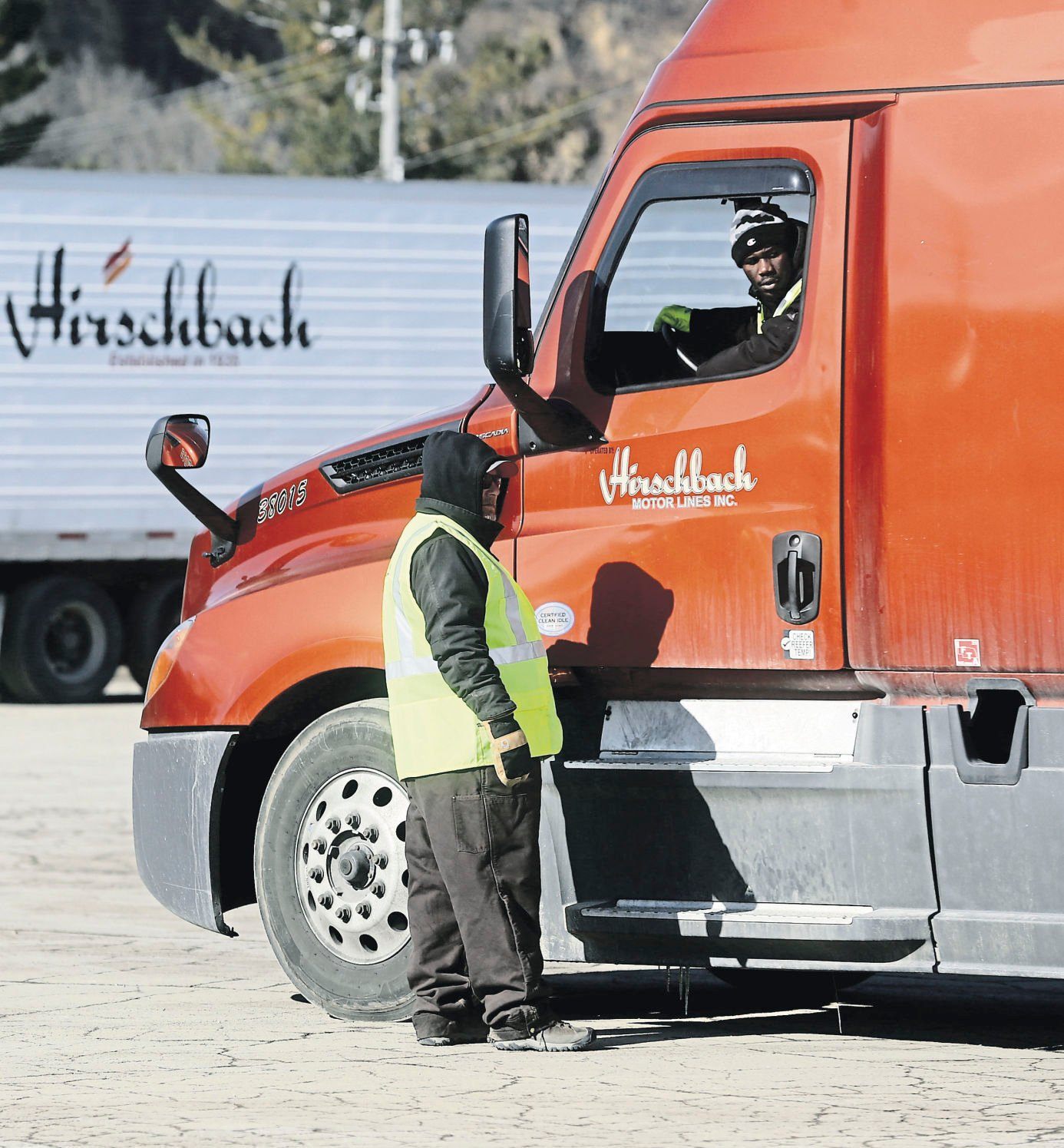 Marty Funke, an instructor at Hirschbach Motor Lines, watches as Mohammed Keita, of Ramsey, Minn., maneuvers his semi-tractor trailer in a parking lot during a commercial driver’s license training program.    PHOTO CREDIT: JESSICA REILLY