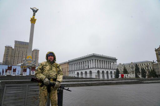 An armed man stands at the Independent Square (Maidan) in the center of Kyiv, Ukraine. Russian and Ukrainian officials say they are standing by to resume talks about their war, though the time and place for negotiations was unknown and hopes for a breakthrough remain low.    PHOTO CREDIT: Efrem Lukatsky