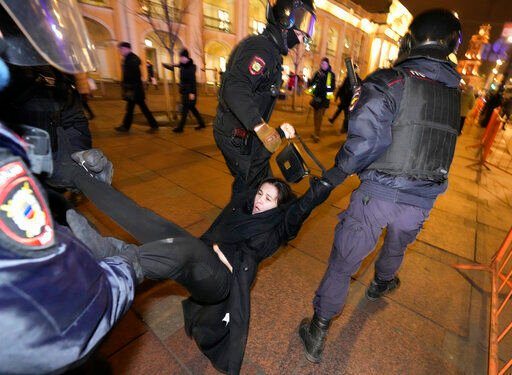 Police detain a demonstrator during an action against Russia