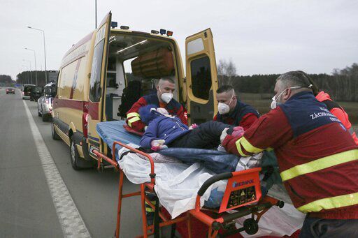 A Czech medical team evacuates Ukrainian child patient Yaroslava Zun, 9, who they picked up from Lviv, at the border crossing in Korczowa, Poland on Wednesday, March 2, 2022, from where she will be transported to Czech city of Pardubice. (AP Photo/Visar Kryeziu)    PHOTO CREDIT: Visar Kryeziu
