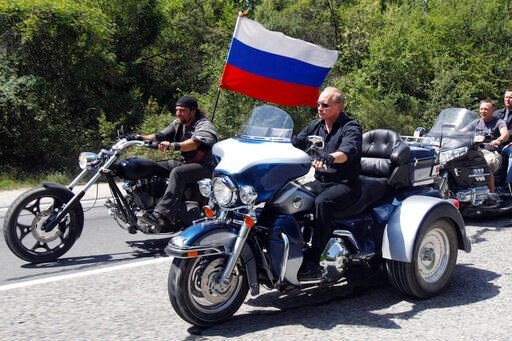 Russian leader Vladimir Putin (foreground) rides a Harley-Davidson Lehman Trike during a visit to Ukraine in 2010. Harley-Davidson halted motorcycle shipments to Russia on Thursday.    PHOTO CREDIT: Sergei Karpukhin