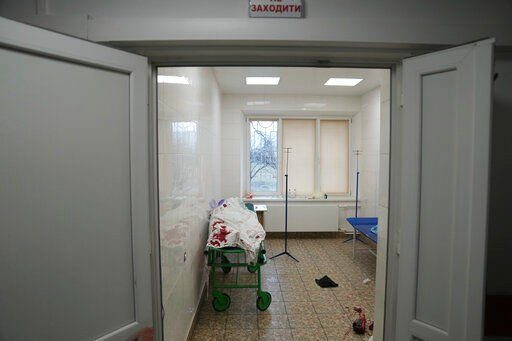 The lifeless body of teenager Ilya, fatally wounded by shelling, Iies on a stretcher at a maternity hospital converted into a medical ward in Mariupol, Ukraine, Wednesday, March 2, 2022. Russian forces have seized a strategic Ukrainian seaport and besieged another. Those moves are part of efforts to cut the country off from its coastline even as Moscow said Thursday it was ready for talks to end the fighting. (AP Photo/Evgeniy Maloletka)    PHOTO CREDIT: Evgeniy Maloletka