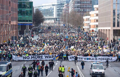 Many thousands of demonstrators walk down Willy-Brandt-Strasse, a main thoroughfare in Hamburg, Germany, carrying banners reading ""No more war"." and ""Another world is possible"." on Thursday, March 3, 2022. The Fridays for Future organization is taking to the streets around the world this Thursday to express solidarity with Ukraine and to protest Russia
