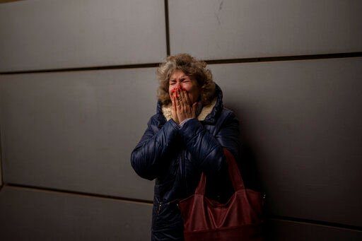Natalia, 57, cries as she says goodbye to her daughter and grandson on a train to Lviv at the Kyiv station, Ukraine, Thursday, March 3. 2022. (AP Photo/Emilio Morenatti)    PHOTO CREDIT: Emilio Morenatti