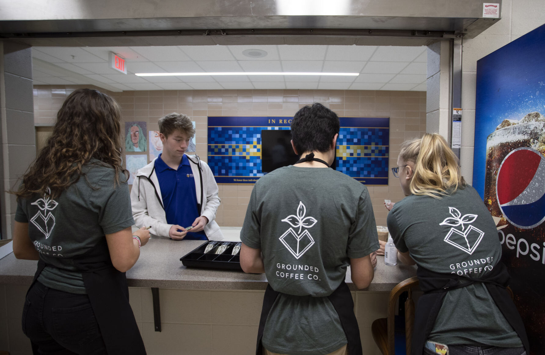 Izzy Ungs (from left), 17, Marco Morel, 17, and Kylie Schmidt, 17, take an order from classmate Luke Zimmerman before class at Wahlert Catholic High School in Dubuque on Wednesday.    PHOTO CREDIT: Stephen Gassman