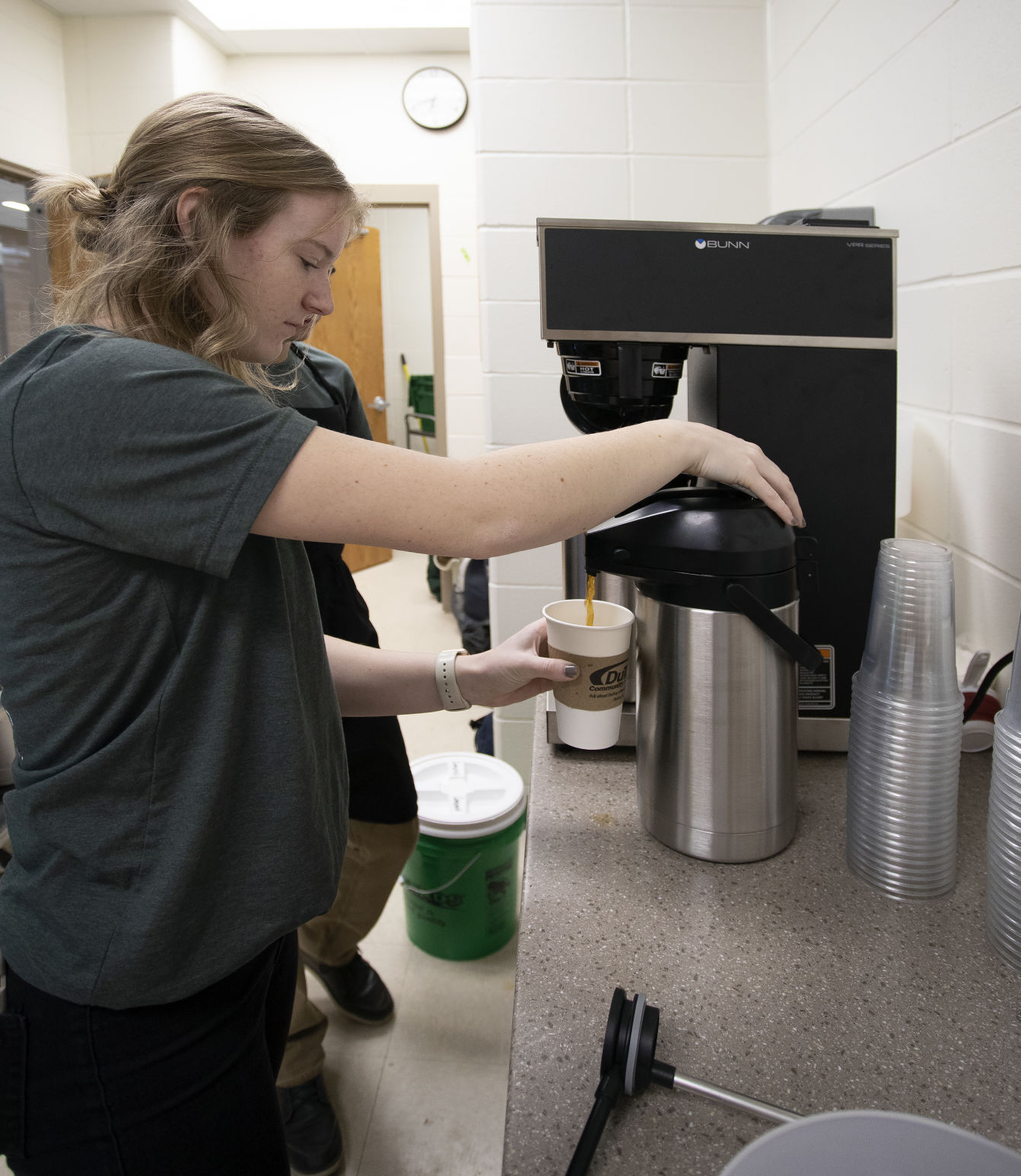 Jamie Vondra, 18, pours a coffee for a customer before school at Wahlert Catholic High School in Dubuque on Wednesday.    PHOTO CREDIT: Stephen Gassman