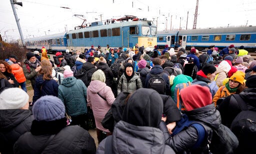 People who have fled from Ukraine wait to board a train traveling to Budapest at the train station in Zahony, Hungary.    PHOTO CREDIT: Darko Vojinovic