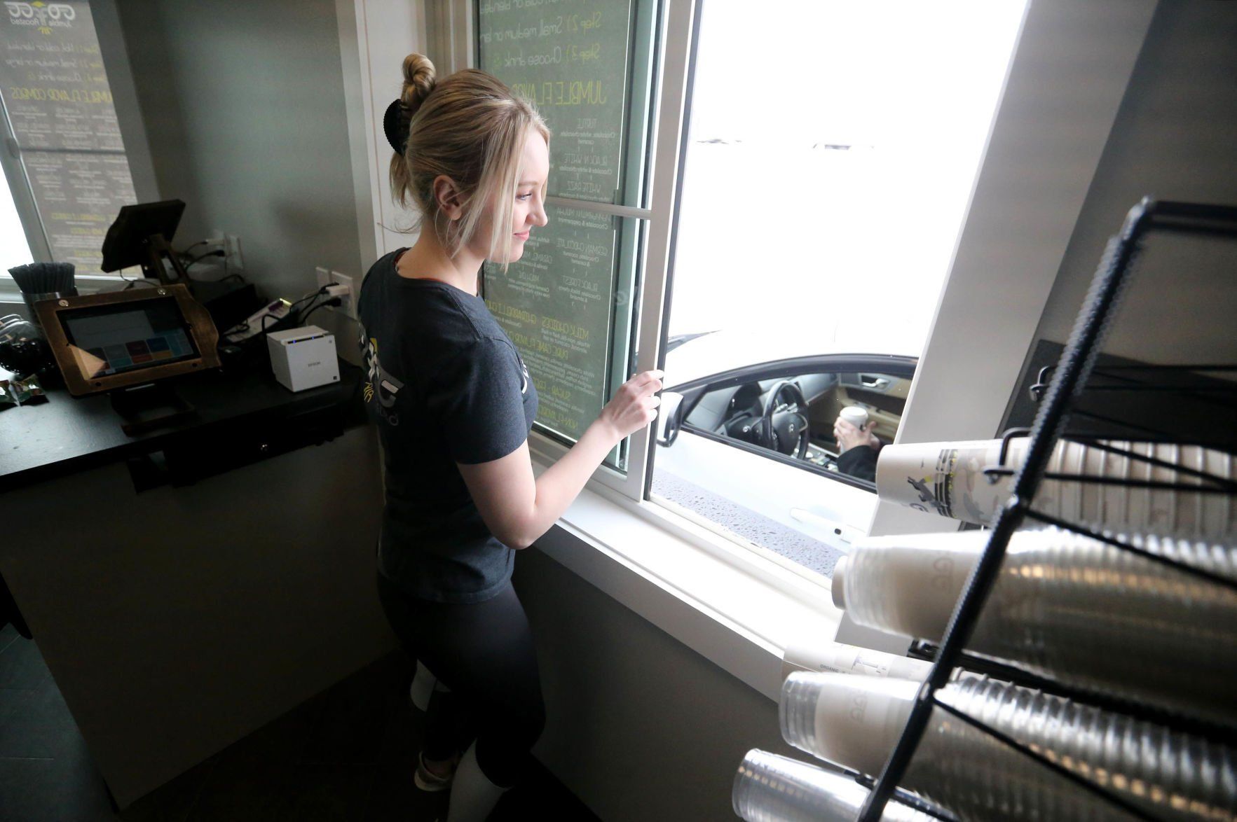 Christiana Merfeld gives drinks to a customer at Jumble Coffee Co. in Peosta, Iowa, on Monday, March 7, 2022. The Thunder Valley Drive location opened on Monday.    PHOTO CREDIT: JESSICA REILLY
