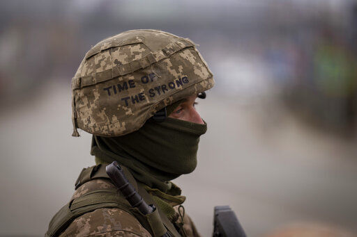 A Ukrainian soldier stands guard at a checkpoint on the outskirts of Kyiv, Ukraine, Monday, March 7, 2022. Russia announced yet another cease-fire and a handful of humanitarian corridors to allow civilians to flee Ukraine. Previous such measures have fallen apart and Moscow