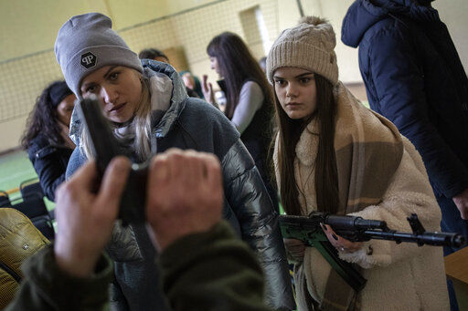 Ukrainian civilians receive weapons training, in the outskirts of Lviv, western Ukraine, Monday, March 7, 2022. Russia