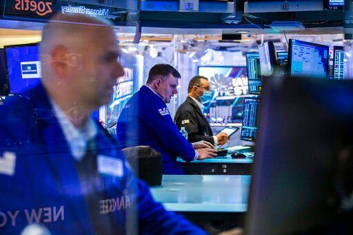 In this photo provided by the New York Stock Exchange, traders work on the floor, Monday, March 7, 2022. Stocks are tumbling on Wall Street Monday as another big leap for oil prices threatens to squeeze inflation