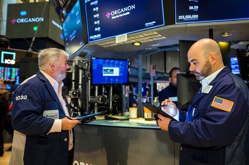In this photo provided by the New York Stock Exchange, traders Edward McCarthy, left, and Fred DeMarco work on the floor, Monday, March 7, 2022. Stocks are falling in morning trading on Wall Street, as more gains for oil prices threaten to worsen the world