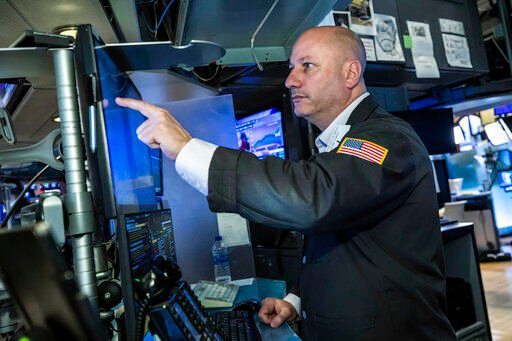 In this photo provided by the New York Stock Exchange, trader John Mauro works on the floor, Monday, March 7, 2022. Stocks are tumbling on Wall Street Monday as another big leap for oil prices threatens to squeeze inflation