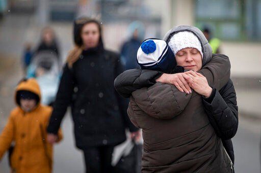 Refugees fleeing Ukraine reunite at the border crossing in Medyka, Poland, Monday, March 7, 2022. Russia announced yet another limited cease-fire and the establishment of safe corridors to allow civilians to flee some besieged Ukrainian cities Monday. But the evacuation routes led mostly to Russia and its ally Belarus, drawing withering criticism from Ukraine and others. (AP Photo/Visar Kryeziu)    PHOTO CREDIT: Visar Kryeziu