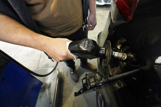 A customer pumps gasoline into his car at a Sam