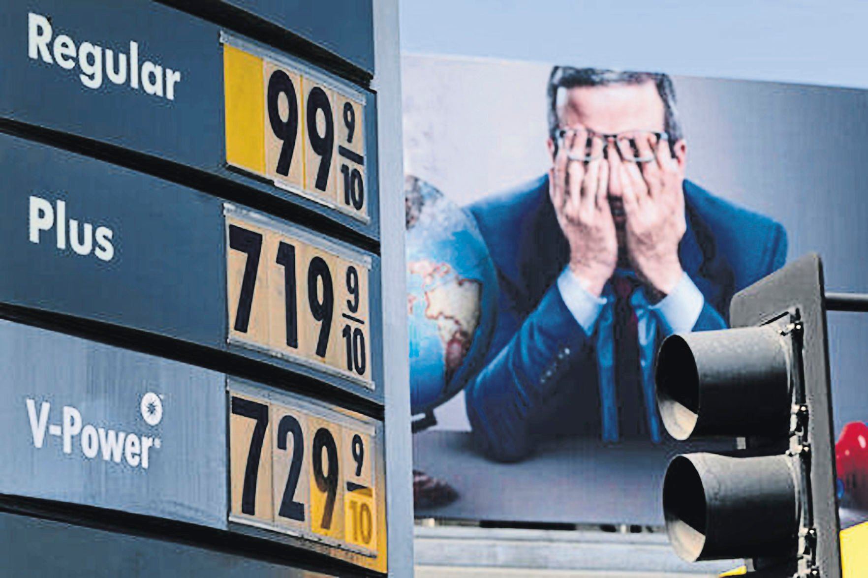 Gas prices in Los Angeles are seen in front of a billboard advertising HBO’s Last Week Tonight. The average price per gallon in the U.S. hit a record-high $4.17 per gallon Tuesday.    PHOTO CREDIT: SYSTEM