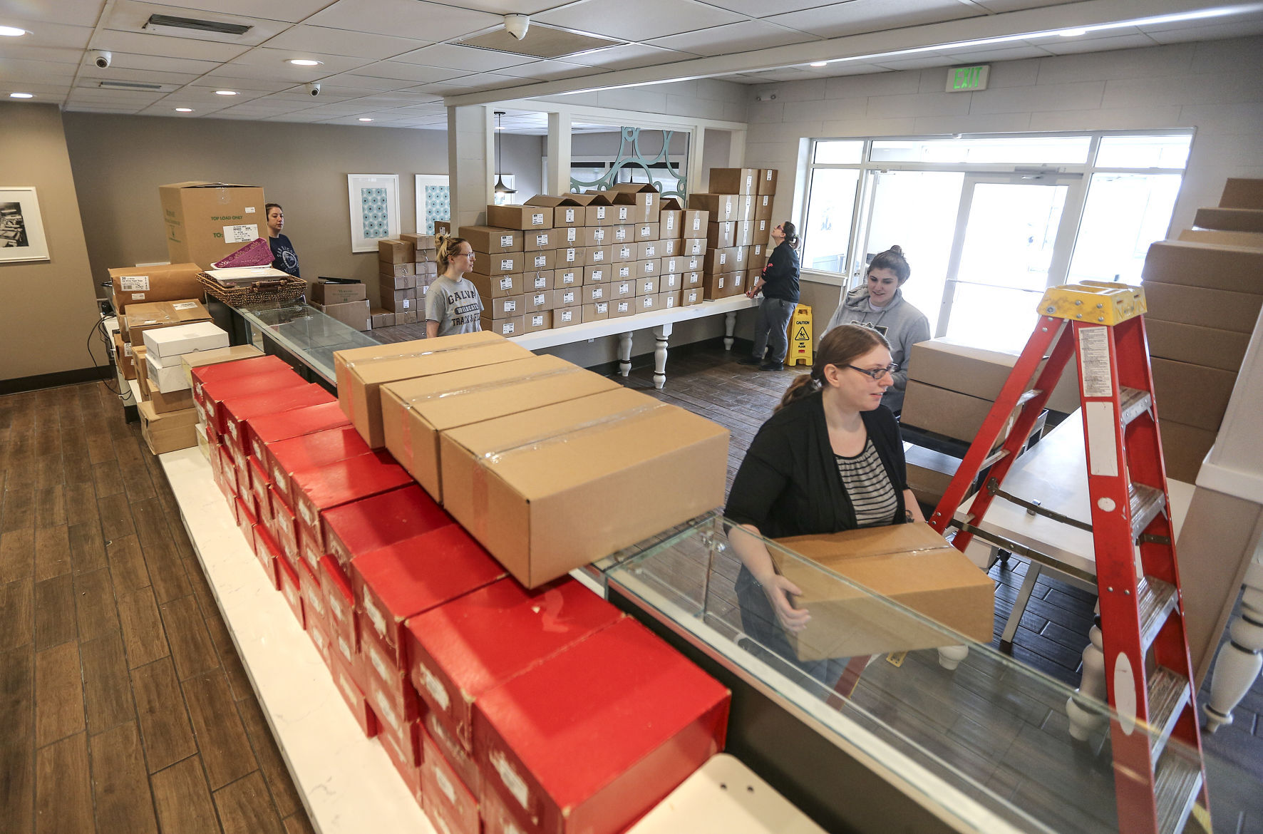 Employee Crystal Hefel carries in supplies at Betty Jane Candies.    PHOTO CREDIT: Dave Kettering/Telegraph Herald