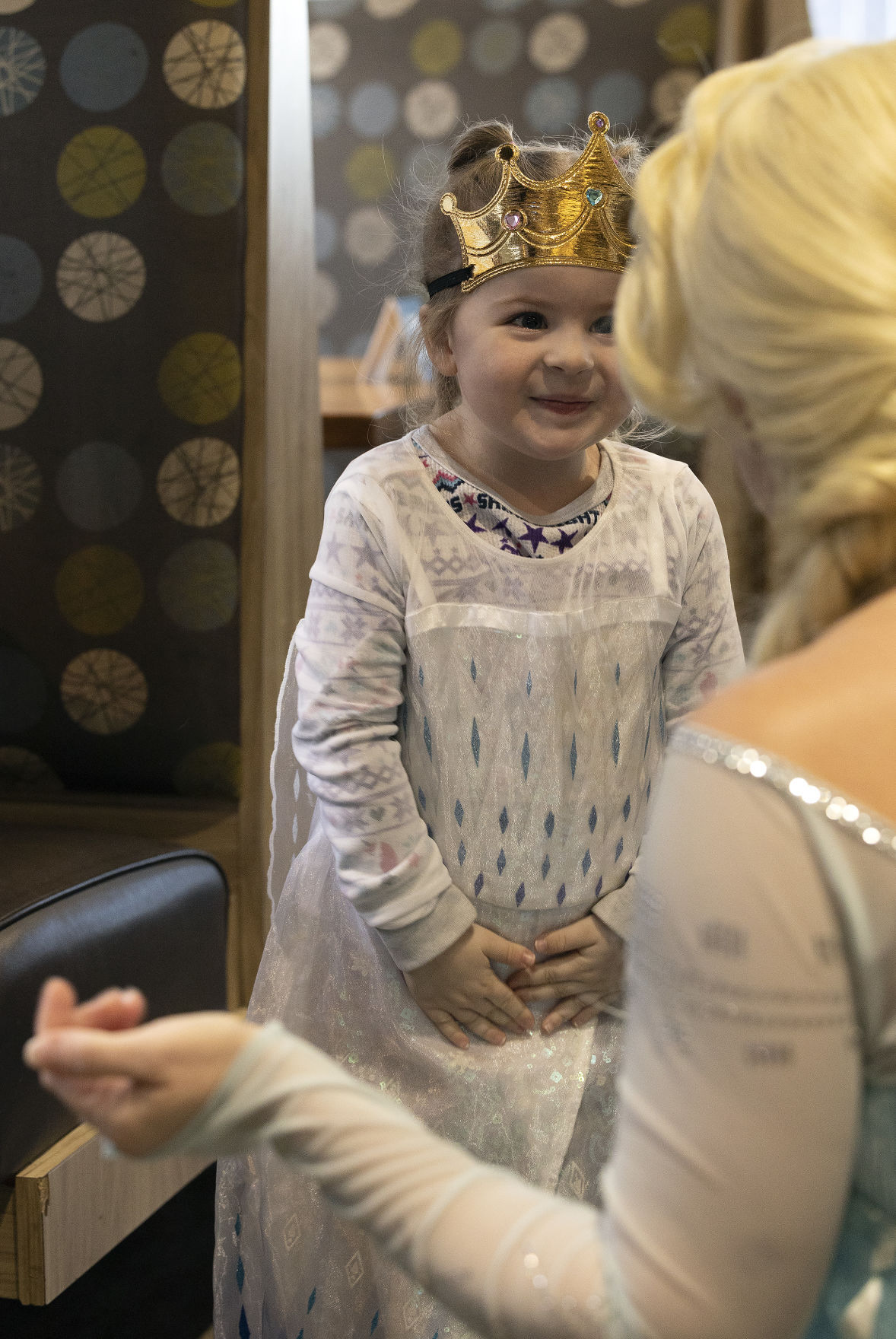 Gentry Fellenzer, 3, of East Dubuque, is excited to meet Traci Yeo, as Elsa, and owner of Royal T Princesses and Superheroes, at Wahlburgers in Hy-Vee on South Locust Street in Dubuque on Friday, March 11, 2022.    PHOTO CREDIT: Stephen Gassman