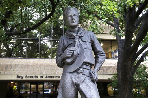 A statue stands outside the Boy Scouts of America headquarters in Irving, Texas. Today, more than two years after the BSA sought bankruptcy protection amid an onslaught of child sex abuse lawsuits, a federal bankruptcy judge in Delaware convenes a trial to determine whether to approve the BSA’s reorganization plan. The plan includes a fund of more than $2.6 billion to compensate tens of thousands of men who say they were molested as children by Scout leaders and others.    PHOTO CREDIT: LM Otero