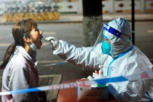 Chinese authorities today tightened anti-virus controls at ports, raising the risk of trade disruptions after some auto and electronics factories shut down as the government fights coronavirus outbreaks.    PHOTO CREDIT: Chinatopix via AP