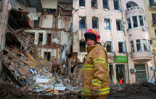 A Ukrainian firefighter works near a destroyed apartment building in Kharkiv, Ukraine, Wednesday, March 16, 2022. Both Russia and Ukraine projected optimism ahead of another scheduled round of talks Wednesday, even as Moscow
