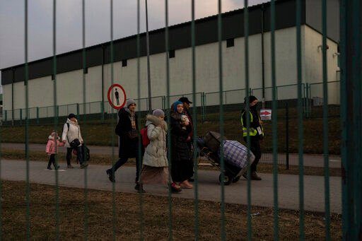 A group of people fleeing Ukraine arrive at the border crossing in Medyka, Poland, on Wednesday, March 16, 2022. Russia