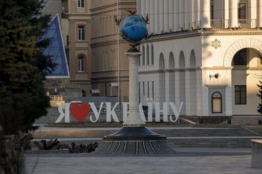 Anti-tank obstacles are placed in the street backdropped by a "I love Ukraine" sign, in downtown Kyiv, Ukraine, Wednesday, March 16, 2022, as authorities declared a 35 hour curfew in the Ukrainian capital. Both Russia and Ukraine projected optimism ahead of another scheduled round of talks Wednesday, even as Moscow