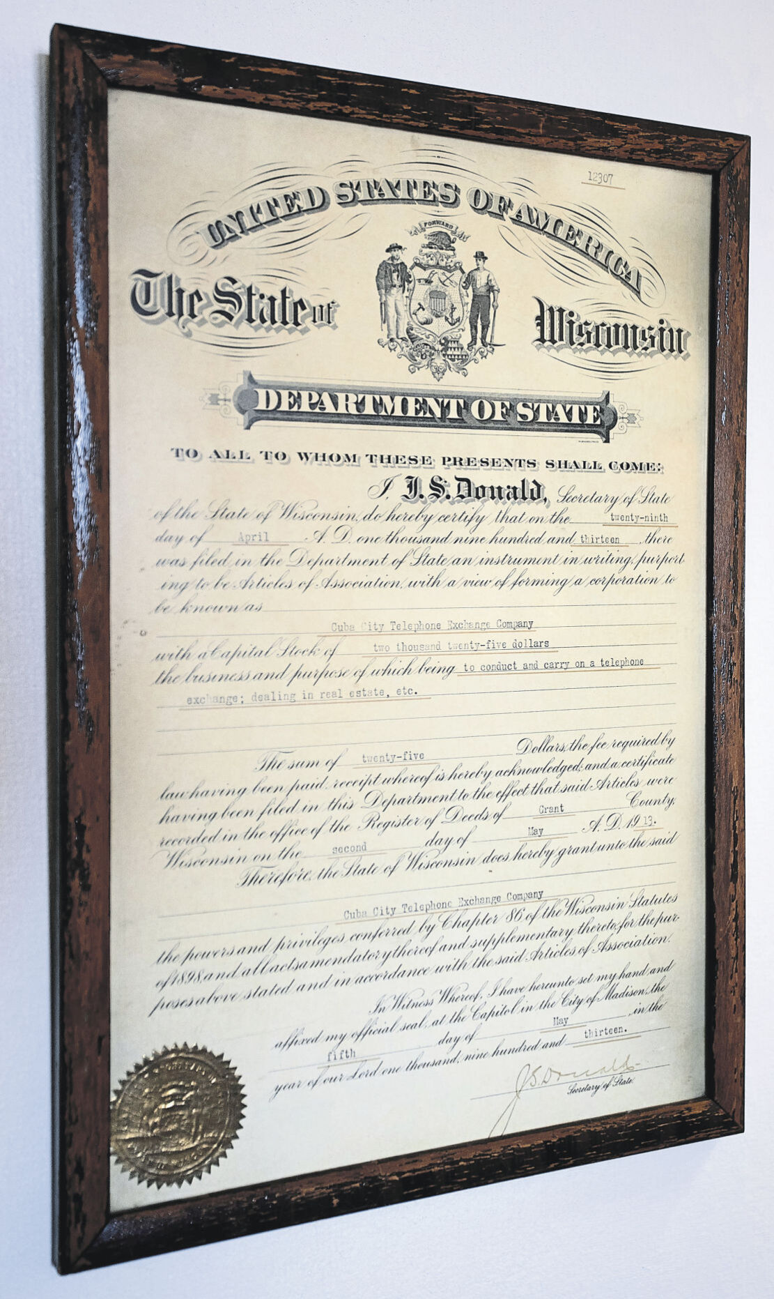 Incorporation document from 1913 signed by the Wisconsin secretary of state on the wall of Cuba City Telephone Co.    PHOTO CREDIT: SYSTEM