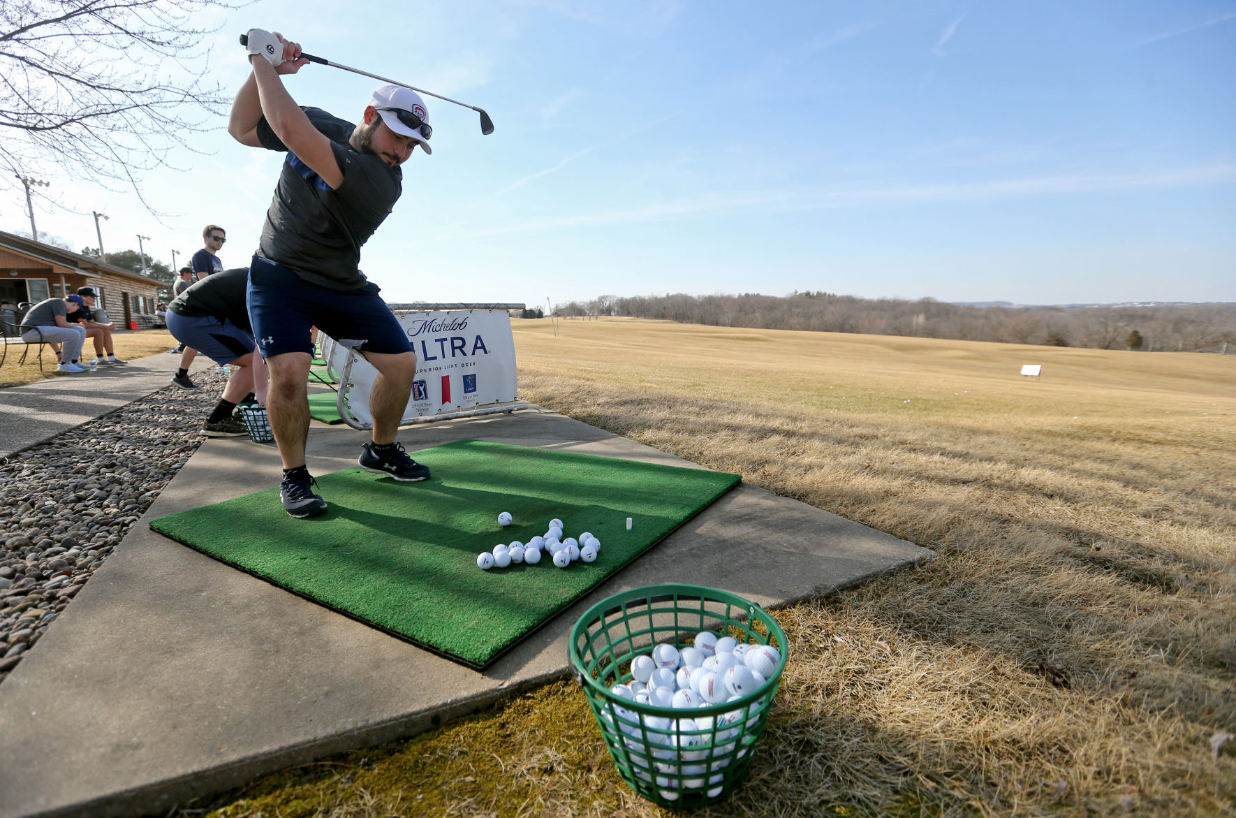 Jerry Jones, a student at the University of Dubuque, hits balls at Derby Grange Golf & Recreation in Dubuque on Wednesday.    PHOTO CREDIT: JESSICA REILLY, Telegraph Herald
