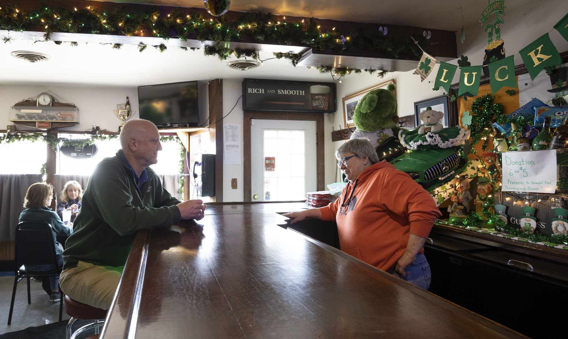 Co-owner Genny Ginter takes a lunch order from Paul Pettinger at West Dubuque Tap on Monday, March 14, 2022.    PHOTO CREDIT: Stephen Gassman